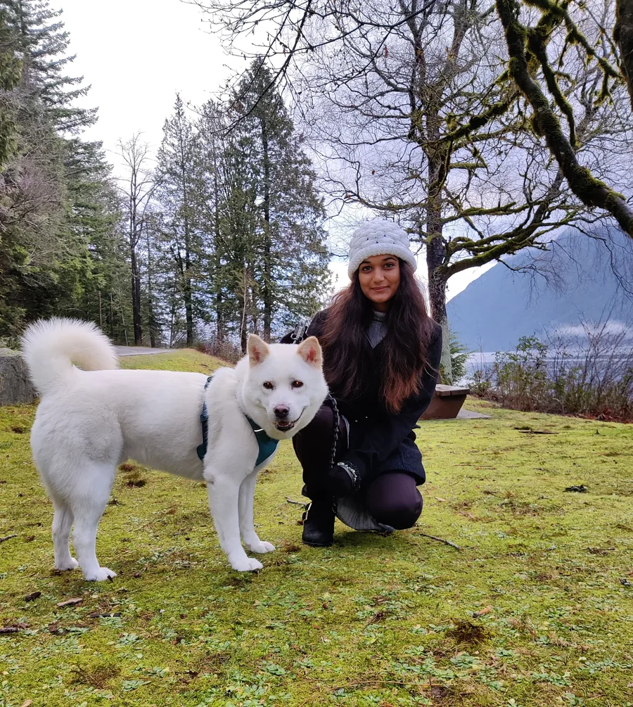 Mahima hugging her dog Ranny in the snow